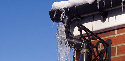 Frozen pipes on brick wall