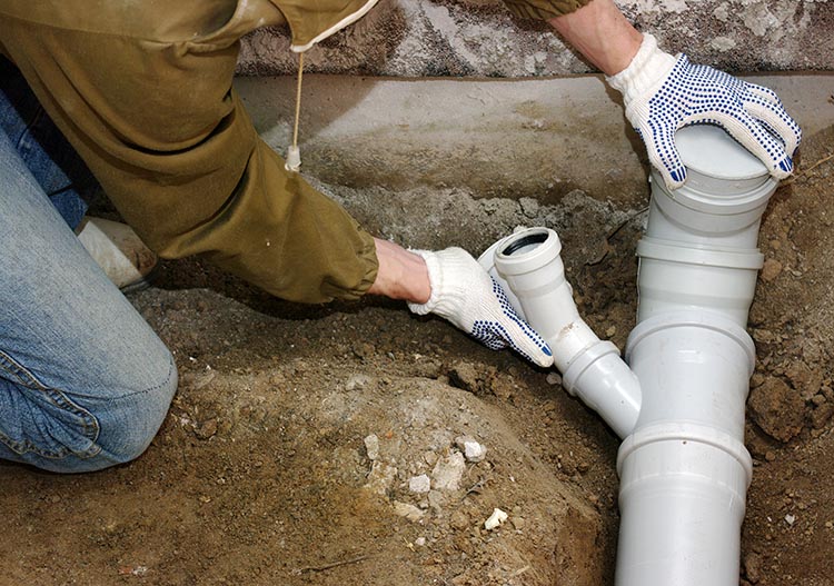 Person repairing sewer line