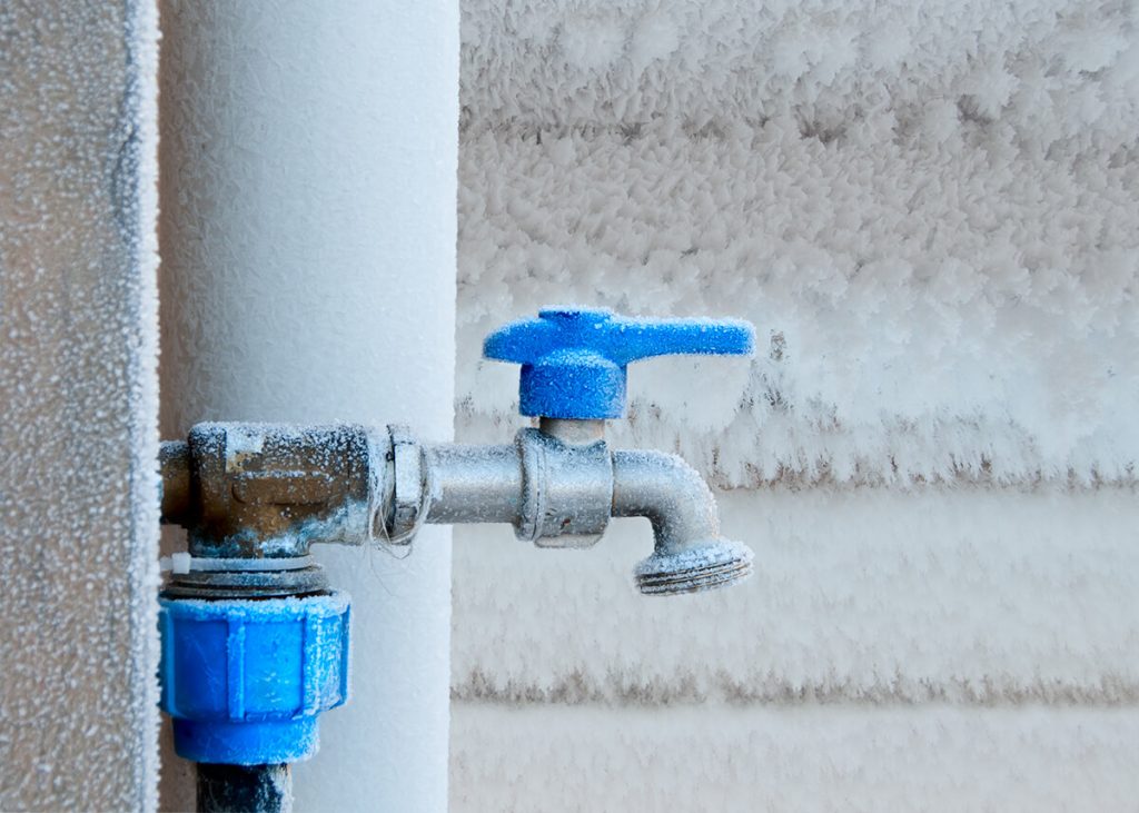 Outdoor water pipe covered with frost