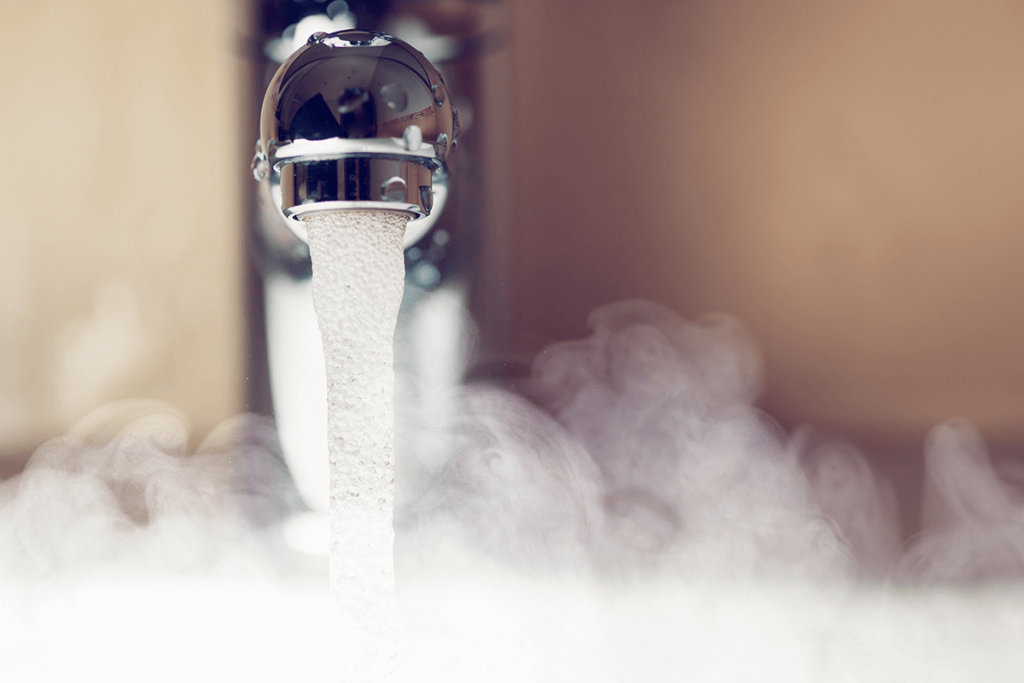 Hot water coming out of sink surrounded by steam