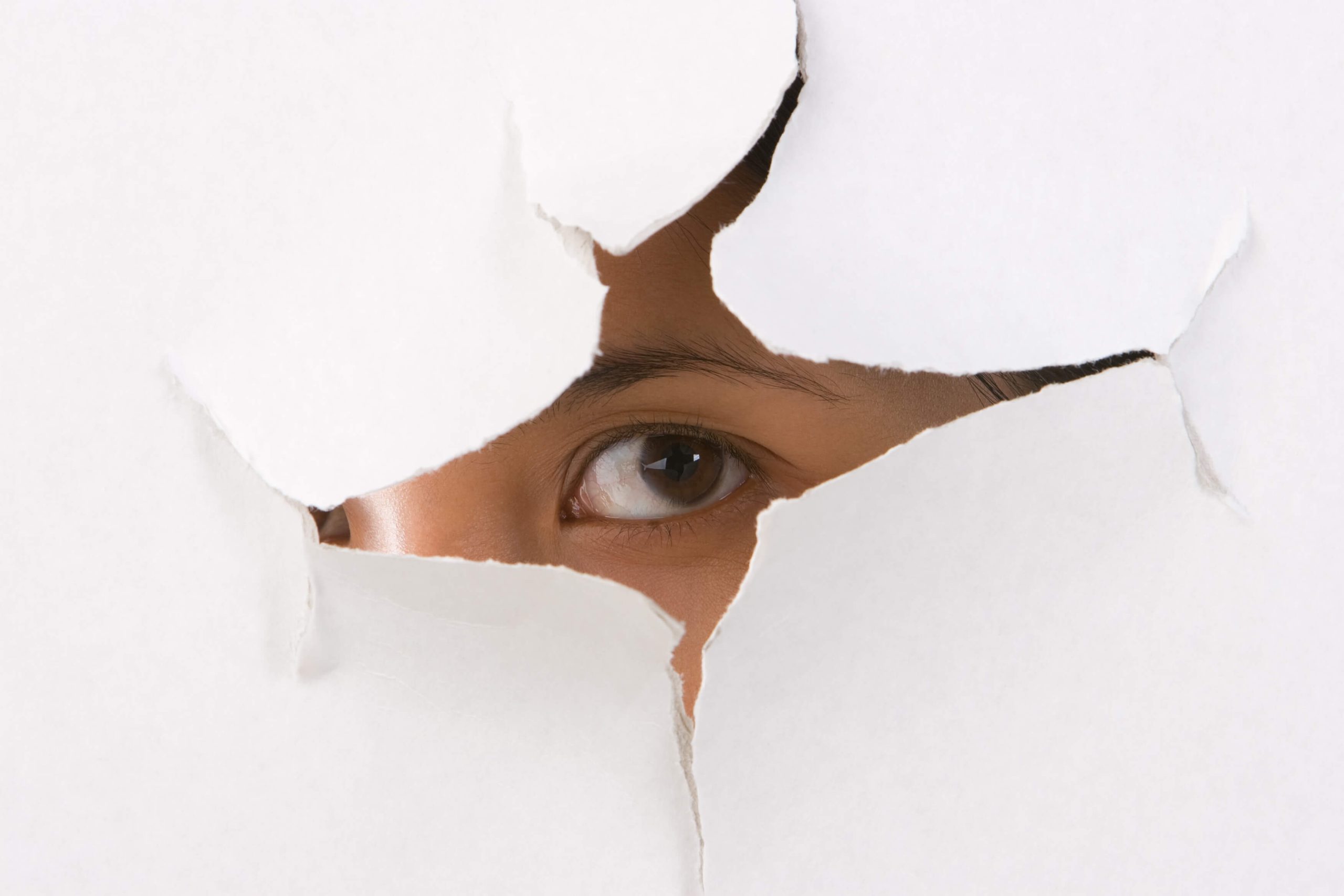 Person looking through hole in wall